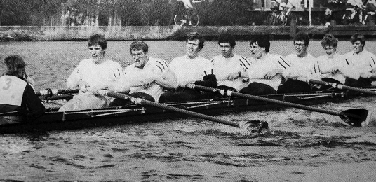 Dr. Hommes rowing with his team in the water