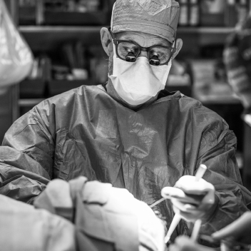 Dr. Thornton in the operating room, wearing a mask and operating eyewear