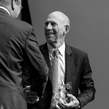 Dr. Thornton shaking hands with a man as he accepts an award