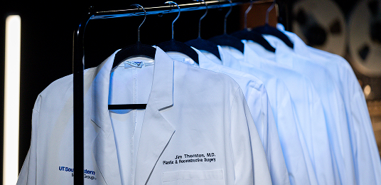 A rack full of medical white coats