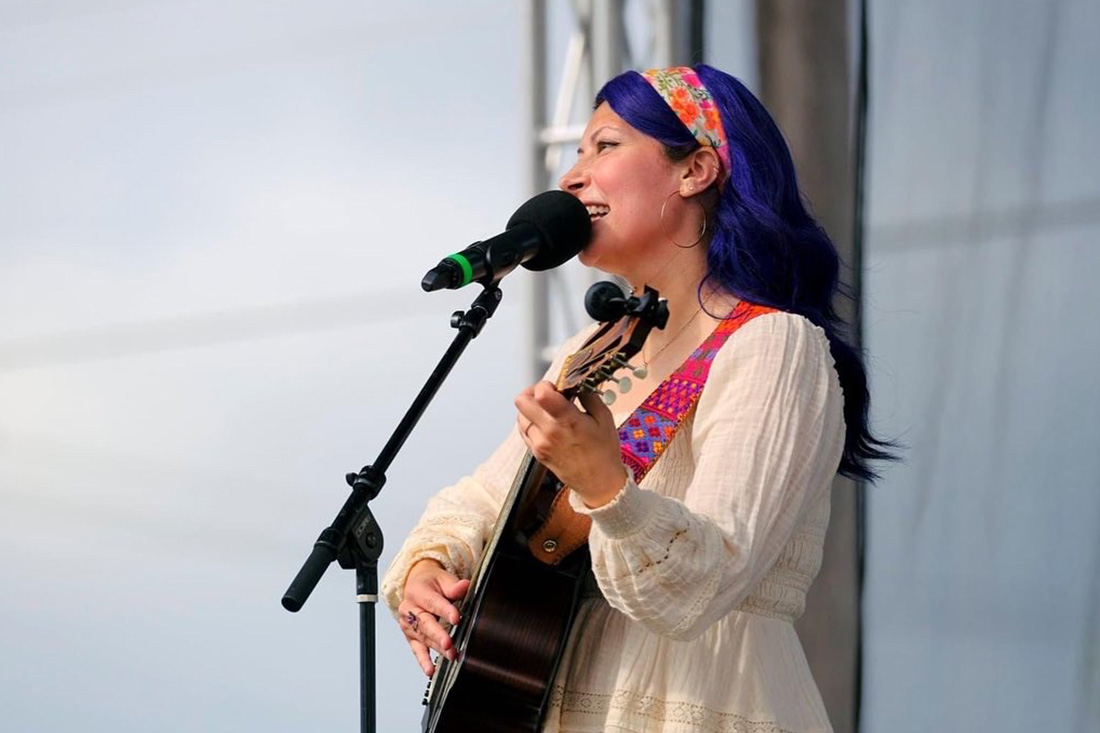 Raquel Lindemann Nguyen singing at outdoor concert