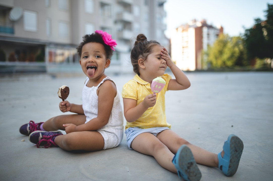 Two toddler girls eating icecream