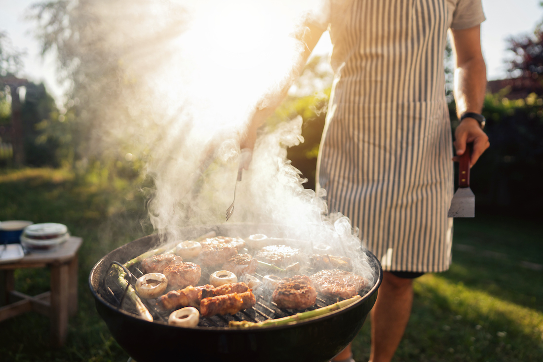 Unrecognizable male chef, grilling the chicken and beef meat, on the bbq grill, during bbq party
