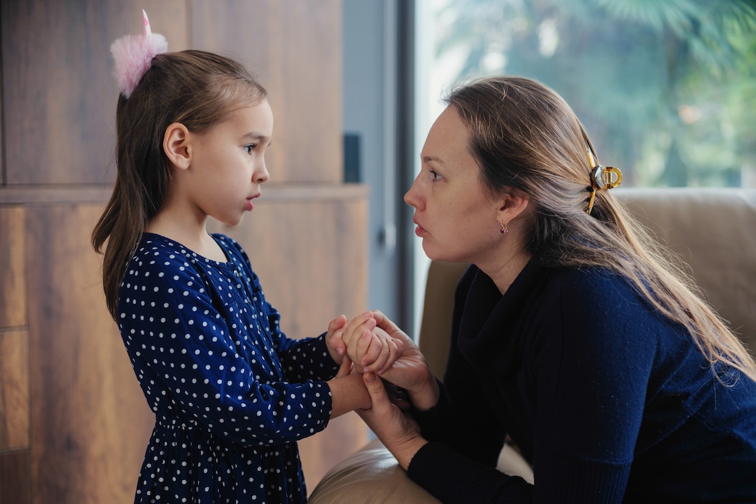 Mother consoles her little sad daughter