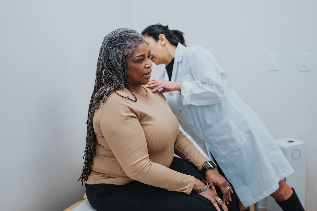 Doctor examining senior woman