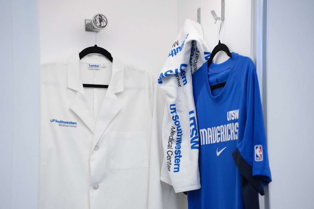 UTSW lab coat next to Dallas Mavs towel and jersey