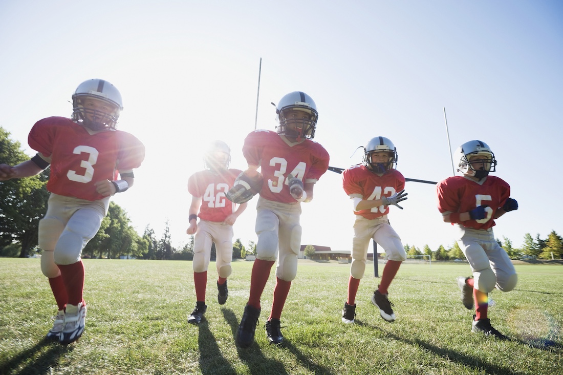  Football players running on field