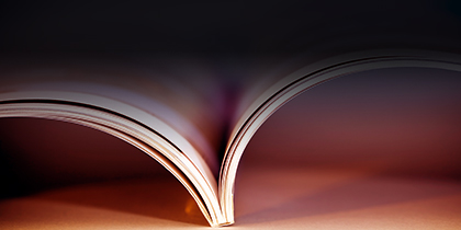 top view of open book pages, orange background
