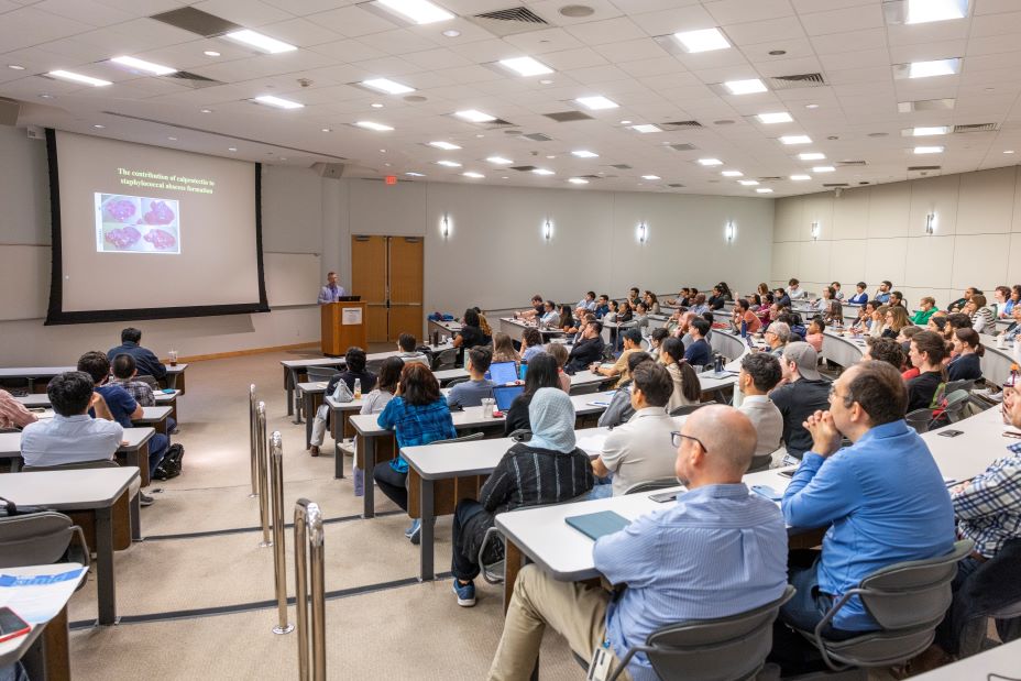 PMID symposium attendees listen to exciting research findings during the keynote speaker's presentation.
