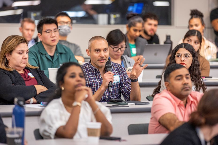 An audience member poses a question to the keynote speaker.
